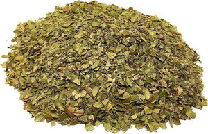 Pile of dried green herbal leaves for wellness and natural remedies