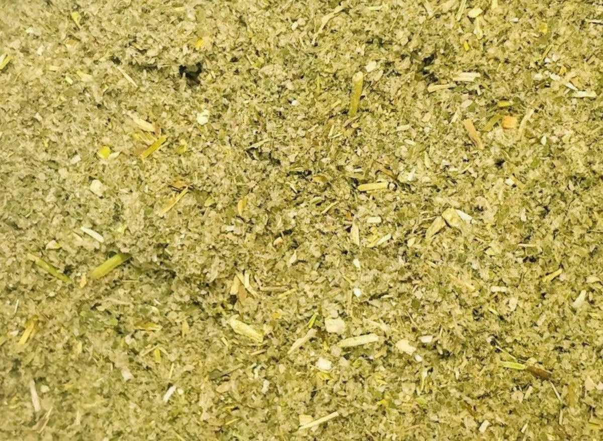 Close-up of herbal smoke blend for wellness, showing finely ground green plant material.