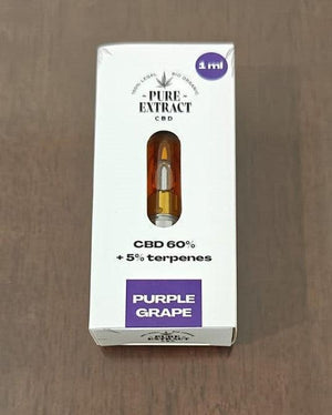 CBD cartridge packaging labeled Purple Grape, 1ml, 60% CBD, 5% terpenes on wood surface