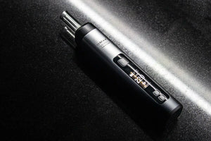Portable dry herb vaporizer with digital display on a black surface, cannabis accessory Malta