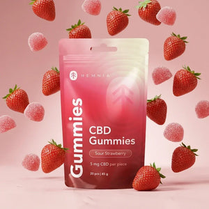 cbd-gummies-strawberry-display.webpHemnia Sour Strawberry CBD Gummies pouch surrounded by strawberries and gummies.