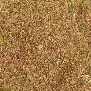 Close-up of a blended herbal mixture with green and purple plant material, ideal for wellness use.