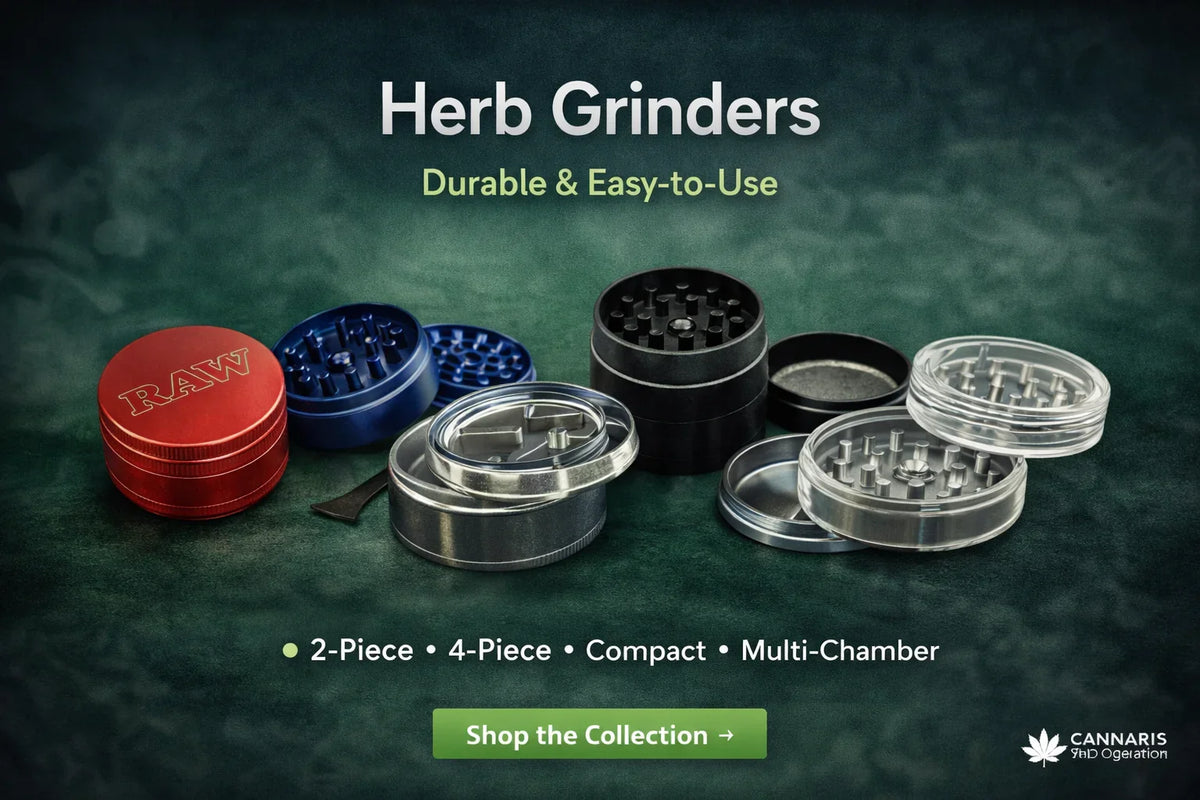 Assorted metal and plastic herb grinders in various colors and styles on a green surface.