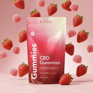 cbd-gummies-strawberry-display.webpHemnia Sour Strawberry CBD Gummies pouch surrounded by strawberries and gummies.