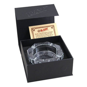 Clear glass ashtray in a black Raw branded box on a white background